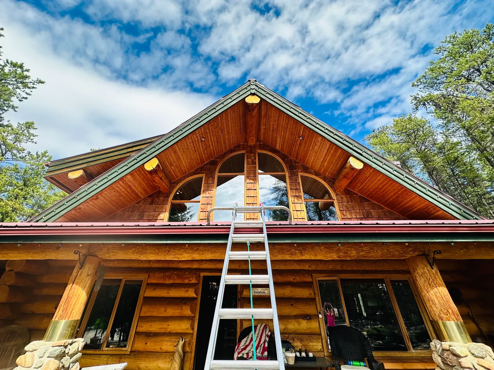 Exterior window cleaning on a timber-frame home in the Peace Region