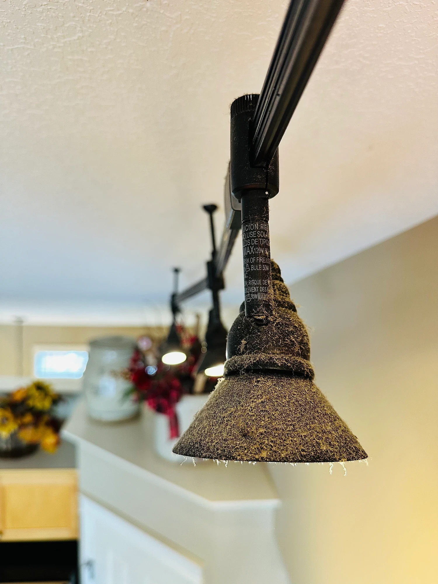 Track light fixture caked in dust and grime before cleaning